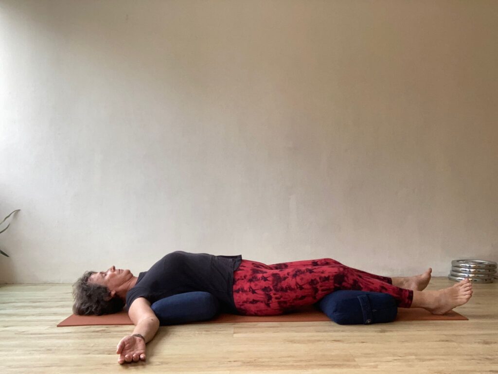 a woman lying on a yoga mat