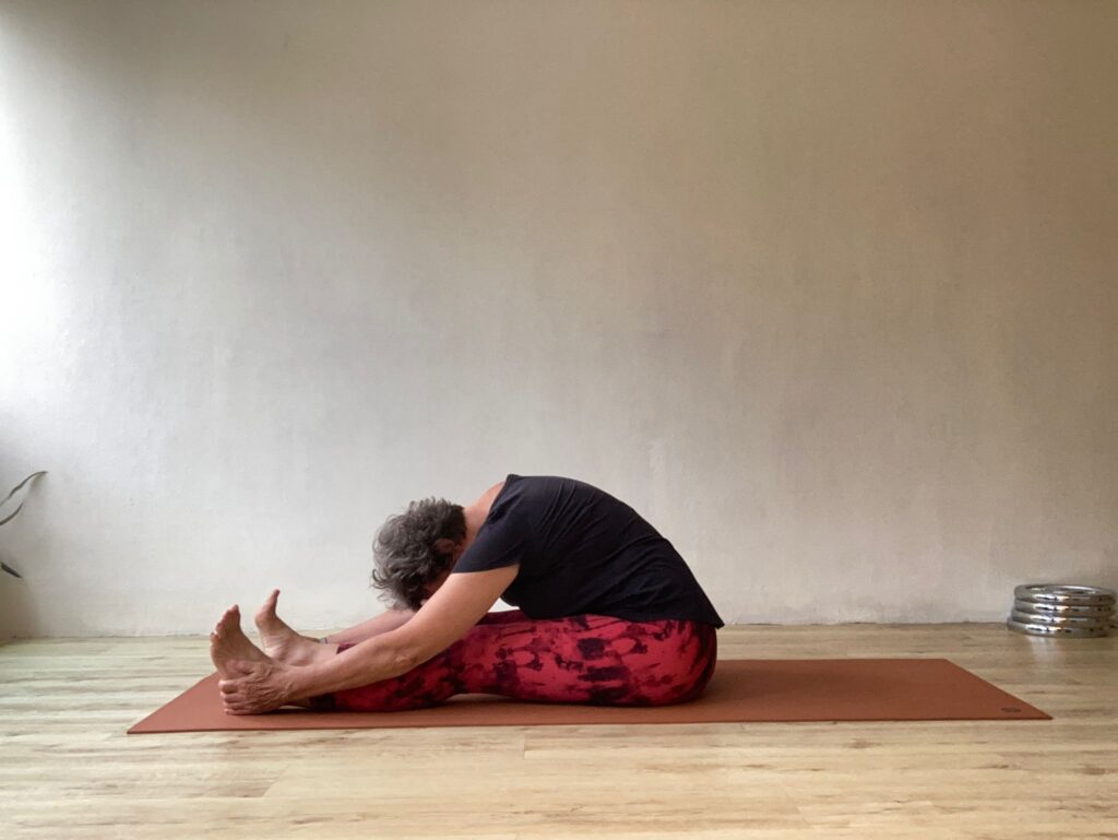 a woman stretching on a mat