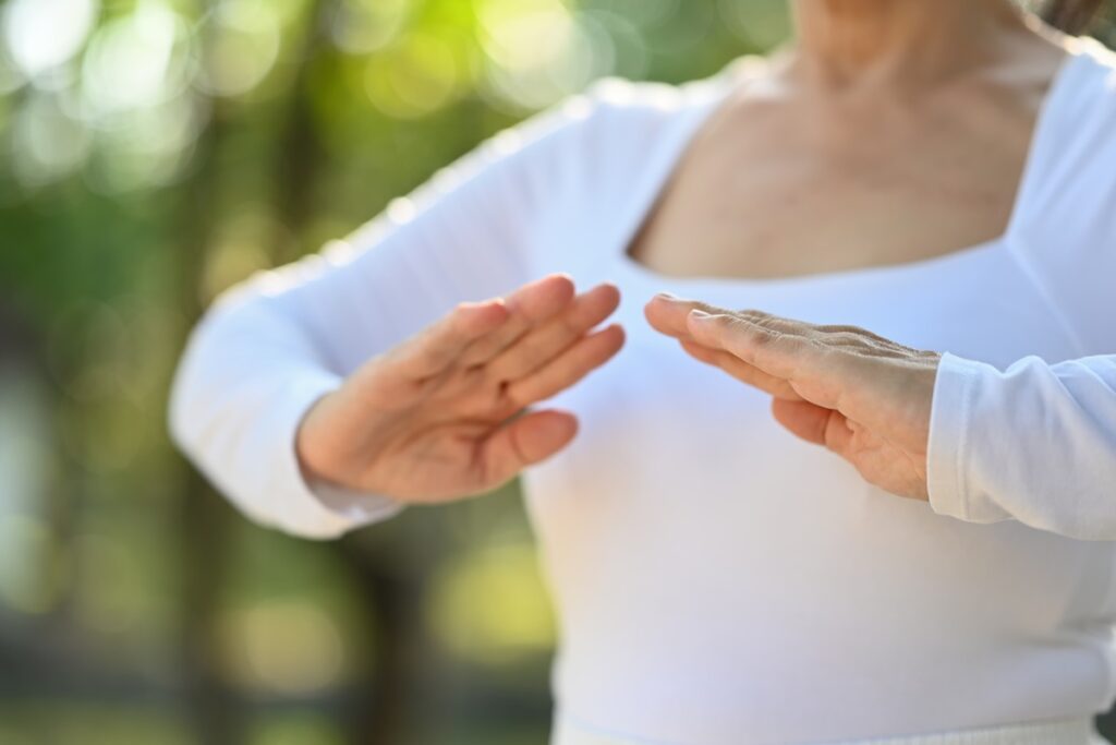 a close-up of a woman's hands, qigong practice