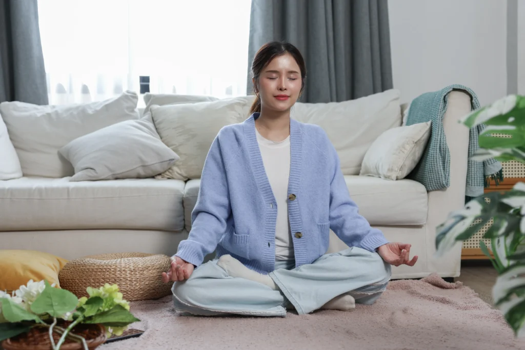 Woman meditating in a cozy room