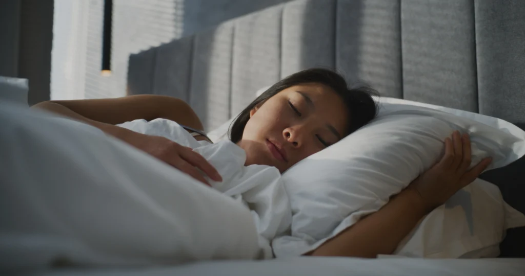 Woman peacefully sleeping in bed.