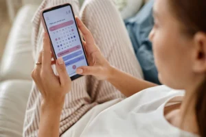 a woman checking her period tracking app